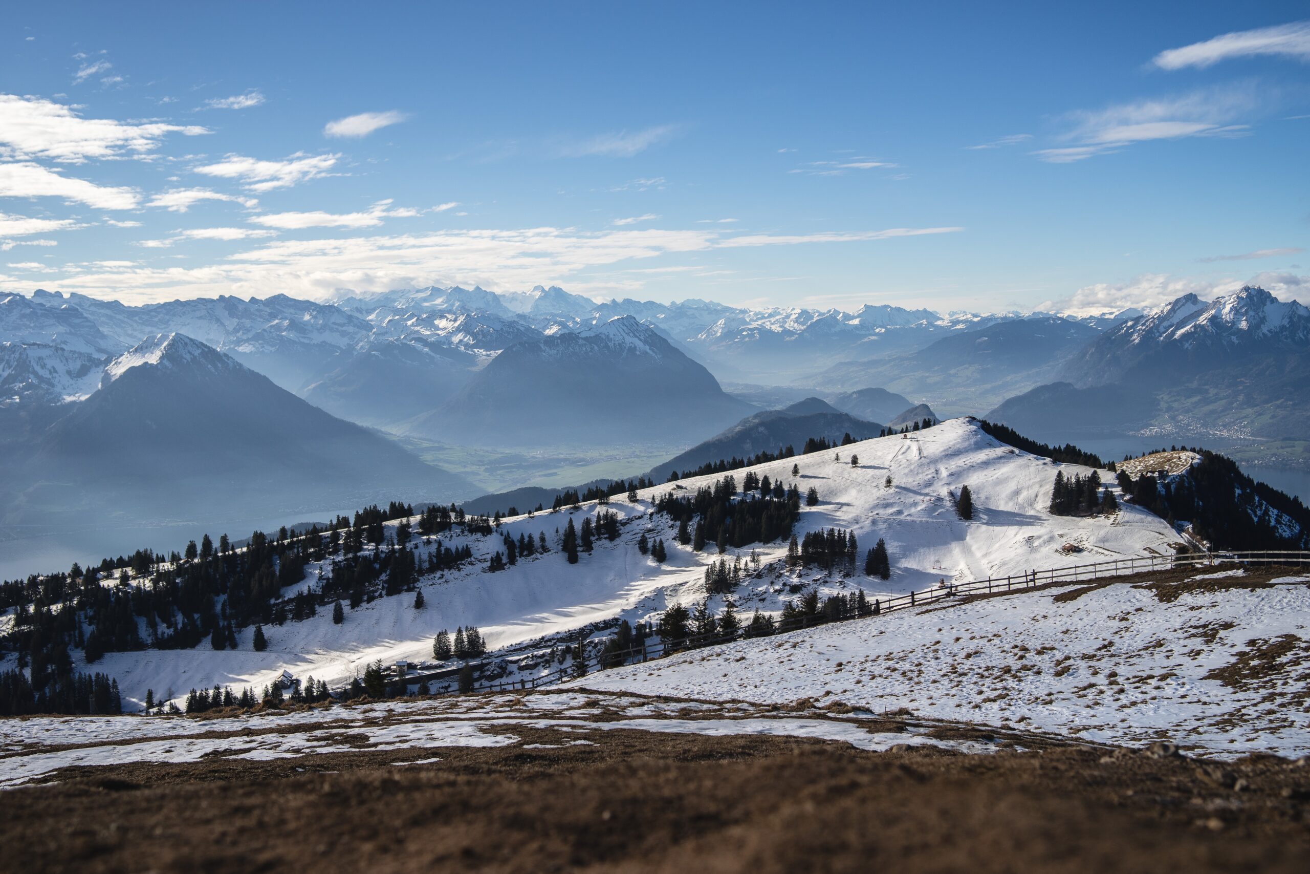 A panoramic shot of the Rigi Mountains in Arth Switzerland, under a blue sky during winter